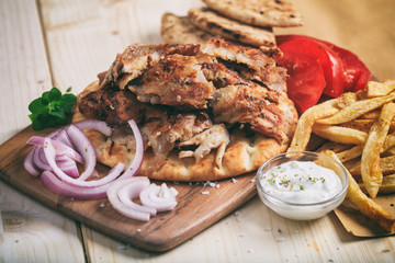 Greek gyros dish on a wooden surface