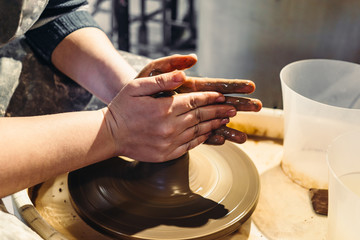 Potter works with clay