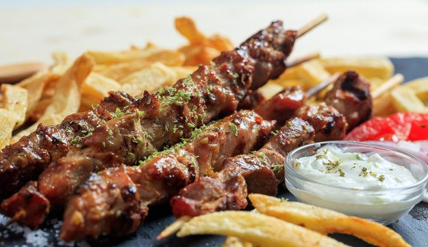 Grilled meat skewers and side dish