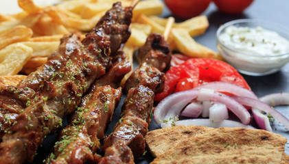Grilled meat skewers and side dish