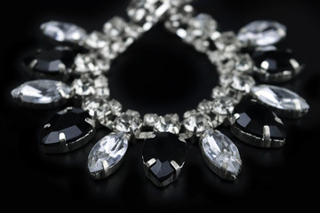 black and white jewelry with dark background. low key picture style of commercial product.