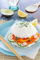 Sushi burger without bread and meat. Burger of white rice, salmon, lettuce, radish, cucumber.