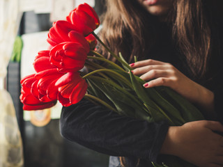 Bouquet of red tulips in hands