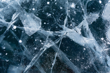 Abstract background of ice and cracks on the surface of frozen Lake Baikal