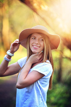 Beautiful and smiling woman in a hat