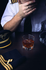 pilot in uniform drinking alcohol © ambrozinio