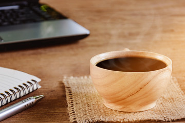 coffee cup and notebook on wood table