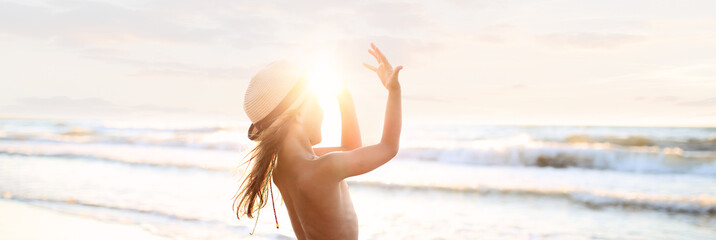 Joyful girl on the beach in the summer sunshine