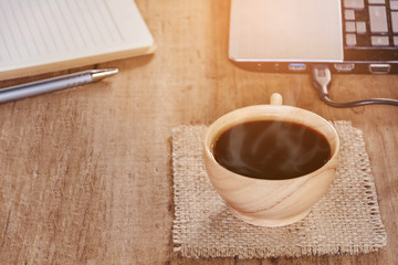 coffee cup and notebook on wood table