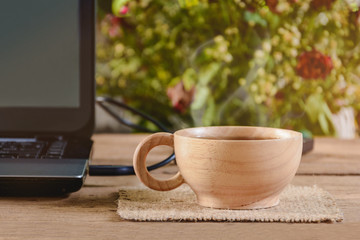 coffee cup and notebook on wood table