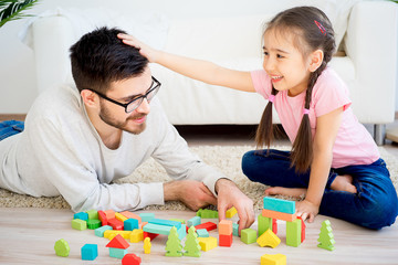 Obraz na płótnie Canvas Family playing with toy blocks