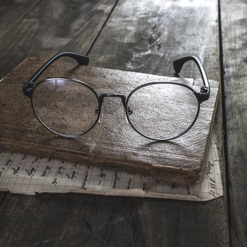 Eyeglasses and old book