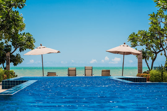 Tropical beach resort with lounge chairs and umbrella