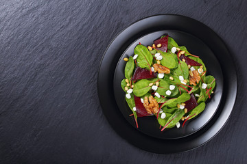 dietary salad on black platters, top view