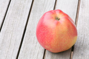red apple on wooden table