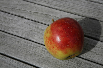 red apple on wooden table
