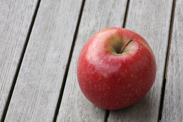 red apple on wooden table