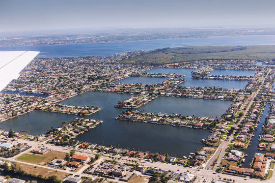 Aerial view of city and gulf Cape Coral, Florida. Typical architecture of South Florida. Large houses built on the banks of canals, canals into the sea.