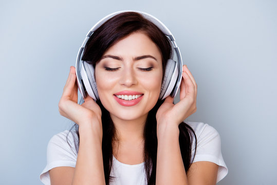 Careless smiling woman in headphones listening to her favourite song