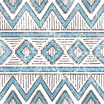 Seamless ethnic pattern. Aztec and tribal motifs. Grunge texture. Blue and white print for your textiles. Vintage background.