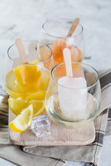 Colorful ice popsicles with wine in glasses