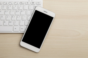 Modern working business desk with keyboard & smart phone. Top view with copy space