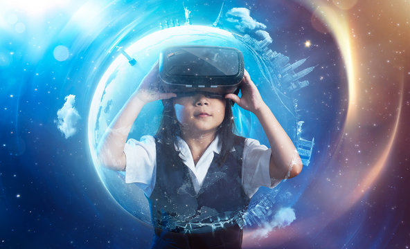 Little asian cute girl wearing virtual reality goggles with amazing cosmic futuristic space virtual imaging background .