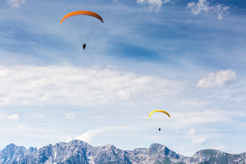 paraglide in front of mountain chain Dachsteinmassiv