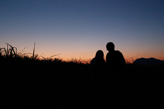 young couple  silhouette mountain