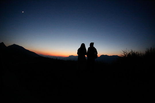 young couple  silhouette  hill