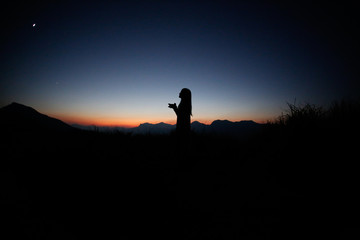 sunset silhouette, young lady in hill