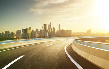 Highway overpass modern city skyline background . Evening scene .