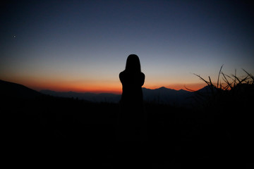 sunset silhouette, young lady in hill