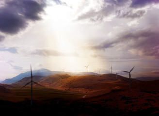 Wind turbines under dramatic sky with in-depth focus © ayakochun