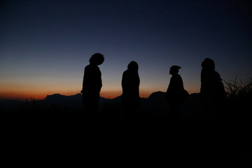 Watch the evening with a group on a hill