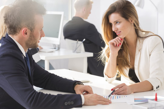 Woman looking teasingly at her colleague