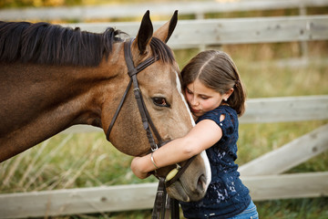 Girl hugging a horse