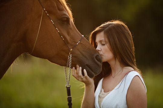 Woman kissing horse muzzle