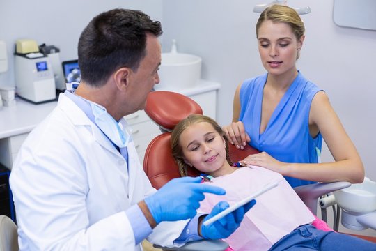Dentist interacting with young patients mother