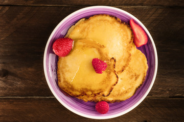 Homemade pancakes with fresh fruit and honey