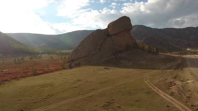 Park Terelj steppe Ulaanbaatar Mongolia. Summer sunny blue sky clouds. Beautiful Mongolian nature. Unique Aerial drone helicopter flight forward Turtle main famous rock tourist attraction