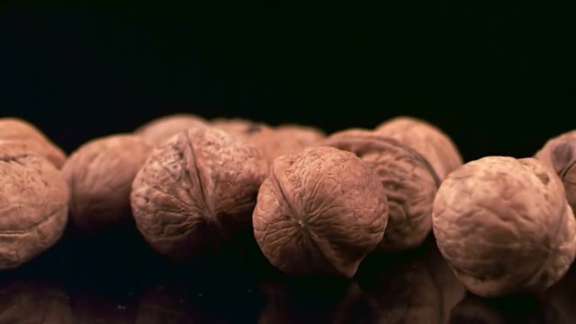 Fresh walnuts on a dark glossy background