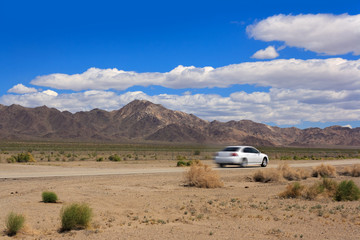 Speeding Car on a Desert Highway