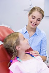 Mother interacting with daughter at dental clinic