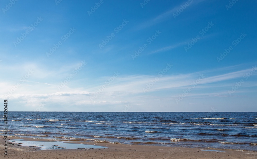 Wall mural jurmala (riga), latvia - april 16, 2017: the panoramic view of sea amid nice blue sky with clouds