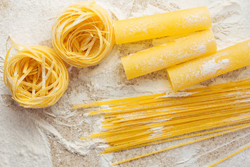 Tagliatelle, cannelonni, spaghetti on the table