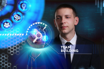 Business, Technology, Internet and network concept. Young businessman working on a virtual screen of the future and sees the inscription: Team building