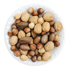 Plate of mixed nuts isolated on white