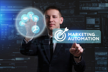 Business, Technology, Internet and network concept. Young businessman working on a virtual screen of the future and sees the inscription: Marketing automation