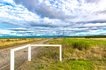 Cloudy sky railway field mountain in new zealand